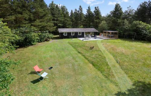 an aerial view of a house and a chair in a yard at Nice Home In Højslev With Kitchen in Højslev