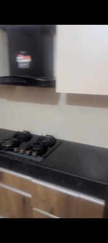 a black stove top oven in a kitchen at Wave executive floors in Ghaziabad