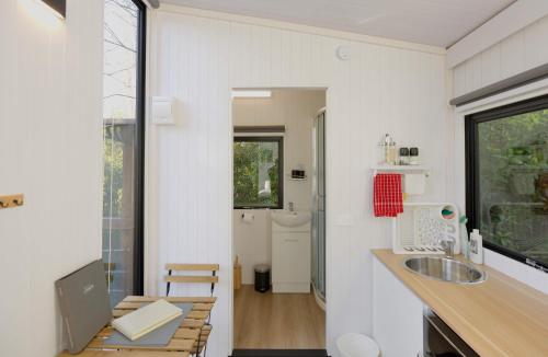 a bathroom with a sink and a counter with a mirror at Cosy Dell by Tiny Away in Herbert