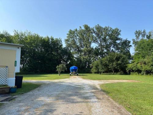 a dirt road next to a field with trees at Port Clinton Lakeside Escape in Port Clinton