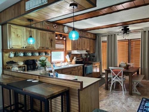 a kitchen with wooden cabinets and a table with a bar at Port Clinton Lakeside Escape in Port Clinton