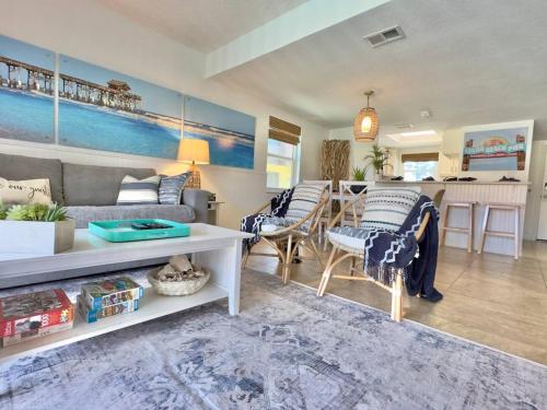a living room with a couch and a table at Pier Pressure Beachfront Wpool in Cocoa Beach