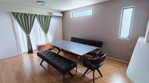 a dining room with a table and chairs at ジャングルの宿 Okinawa in Uruma