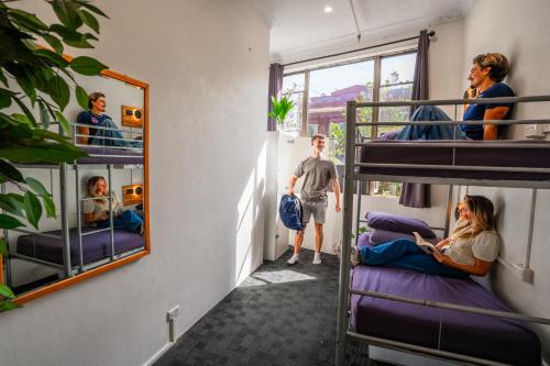 a group of people in a room with bunk beds at Mad Monkey East Side in Sydney
