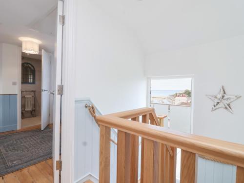 a staircase in a house with a starfish on the wall at Still Waters in Brixham