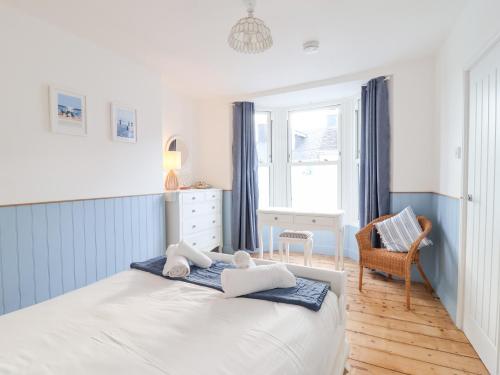 a bedroom with a bed with towels on it at Still Waters in Brixham