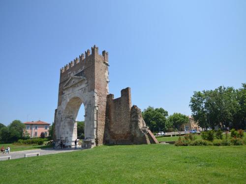an old stone arch in a park with green grass at Cozy 2-Bed Apartment, Petrella in Petrella Guidi
