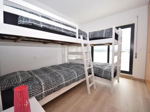 Un dormitorio con dos literas y un escritorio. en Holiday Home Nazaré Beach for Surfing, en Famalicão