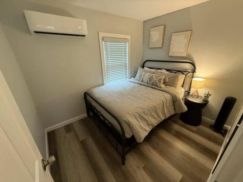 a small bedroom with a bed and a window at Barnacle Bay - Perfect Location Near The Beach in Hampton