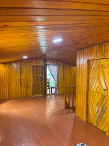 an empty room with wooden walls and a wooden door at Villa Nur Aliya in Bira