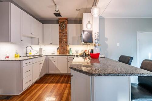 a kitchen with white cabinets and a counter top at Historic Comfy German Village Haus sleeps6petsOK in Columbus