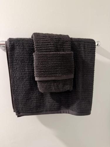 a pile of towels hanging on a towel rack at Barnacle Bay - Perfect Location Near The Beach in Hampton