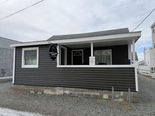 a black house with a sign in the window at The Stuffed Quahog - Perfect Location Near Beach in Hampton