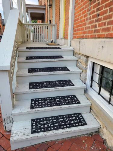 a set of stairs in front of a brick building at Walkable And Cozy German Village Hauspets Ok in Columbus