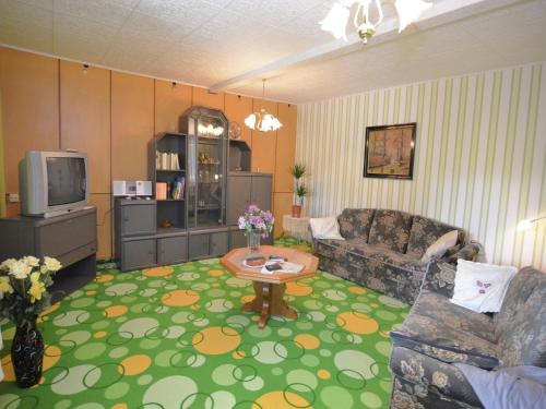 a living room with a couch and a table at Ferienhaus in Cattenstedt Harz mit Garten in Cattenstedt