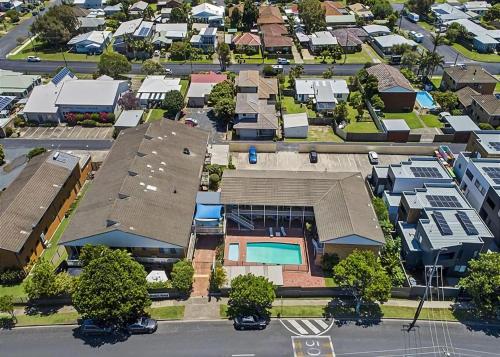 an aerial view of a city with a house at Coasters 25 in Sawtell