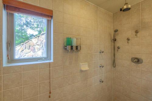 a bathroom with a shower with a window at Stunning Sunsets, Luxe Lodging, Sauna And Spa in Eastsound