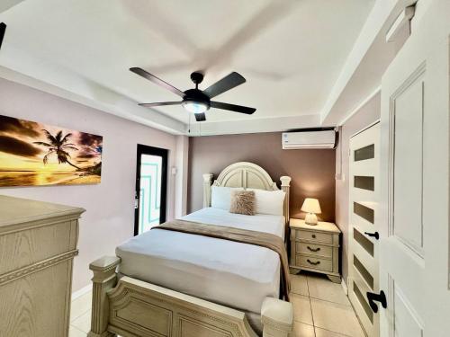 a bedroom with a bed and a ceiling fan at Pineridge Hideaway 1 Bedroom Apartment #1 in Arouca