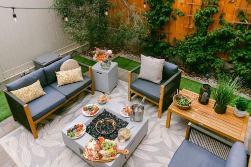 a patio with couches and a table with food on it at Luxe Ob Retreat Sauna, Bikes & Beach Nearby in San Diego