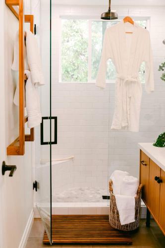 a bathroom with a shower with a robe on a window at Luxe Ob Retreat Sauna, Bikes & Beach Nearby in San Diego