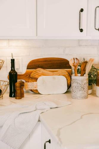 a kitchen counter with a cutting board and a bottle of wine at Luxe Ob Retreat Sauna, Bikes & Beach Nearby in San Diego