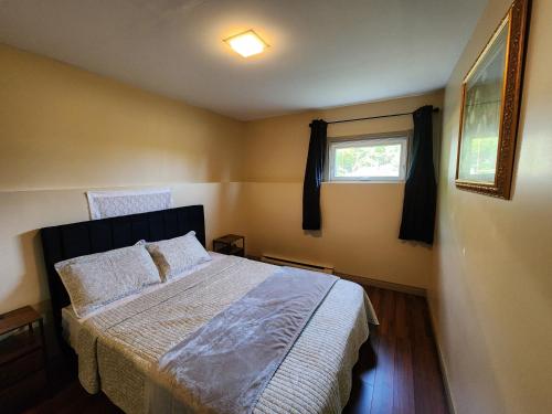 a bedroom with a bed and a window at Two bedroom apartment in Torbay in Torbay