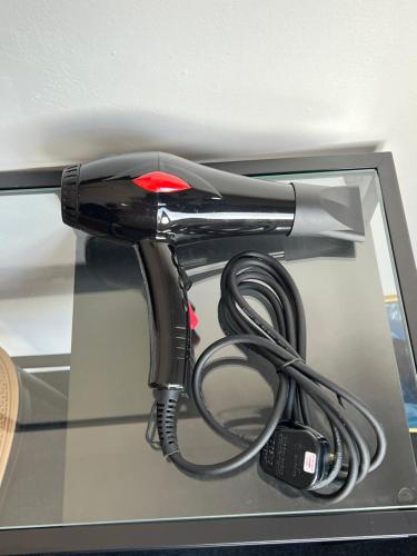 a blow dryer on top of a shelf at Quee Hotel in George Town