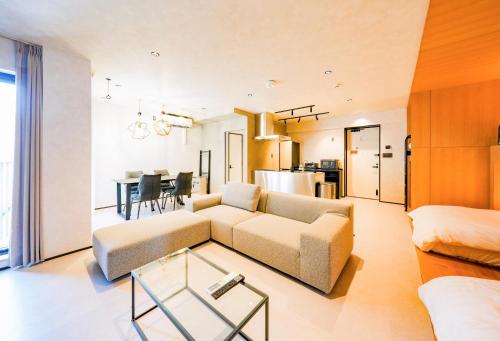 a living room with a couch and a table at NESTo KAMATA in Tokyo