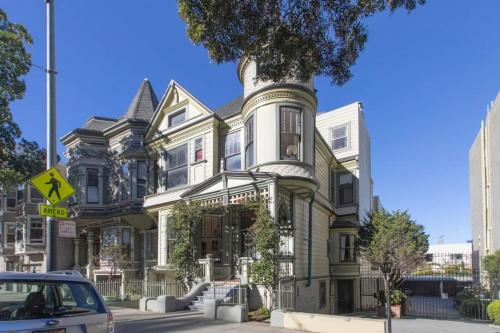 a green house with a tree in front of it at Gorgeous Victorian Flat in San Francisco