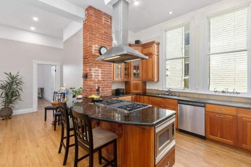a kitchen with a counter and a brick wall at Gorgeous Victorian Flat in San Francisco