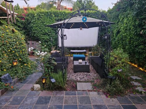 a gazebo with a screen in a garden at Tranquility at the House of Alchemy Hollywood in Los Angeles