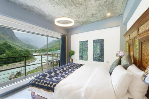 a bedroom with a bed and a large window at Walnut Riverside Resort in Kāgān