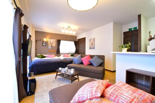 a living room with a couch and a living room with at Alphabed広島平和大通り in Hiroshima