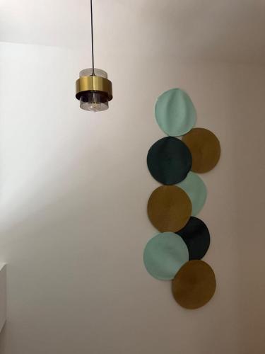 a wall with a bunch of different colored circles at Hotel Tierra Dorada in Guayaquil