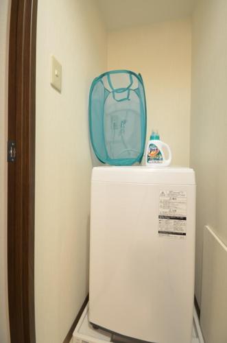 a blue bag sitting on top of a refrigerator at Alphabed広島平和大通り in Hiroshima