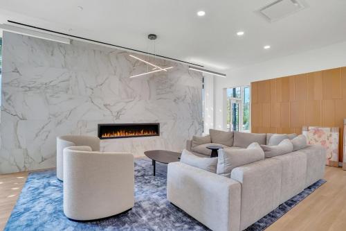 a living room with a couch and a fireplace at New condo Great amenities Near Skytrain in Coquitlam