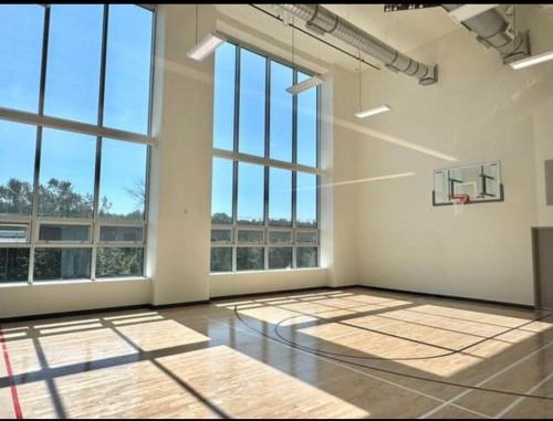an empty room with a basketball hoop and windows at New condo Great amenities Near Skytrain in Coquitlam