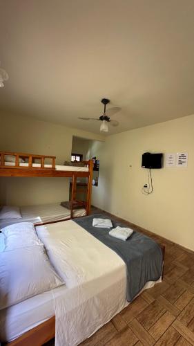 a bedroom with two bunk beds and a flat screen tv at Estalagem Rua Direita in Pirenópolis