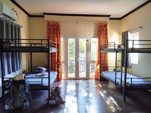 a room with three bunk beds and a window at 88 Ehome Noibai Airport in Hanoi