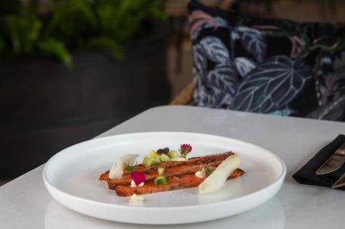 a white plate with food on a table at The Clements Hotel in Cambridge