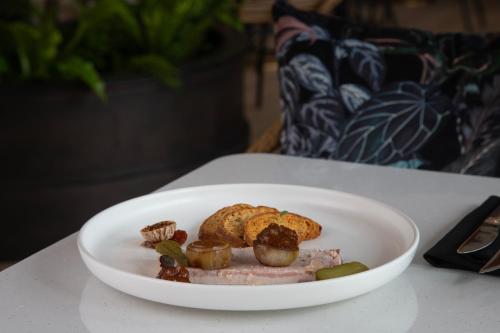 a white plate with food on a table at The Clements Hotel in Cambridge