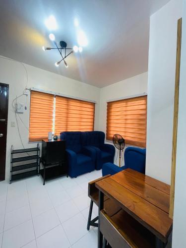 a living room with a blue couch and a table at Richviel Transient House Lucena City Unit1 in Lucena