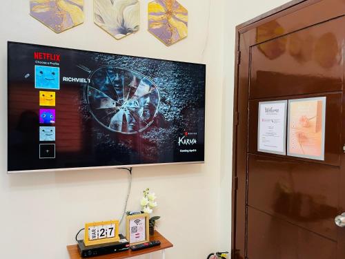 a flat screen tv hanging on a wall at Richviel Transient House Lucena City Unit1 in Lucena