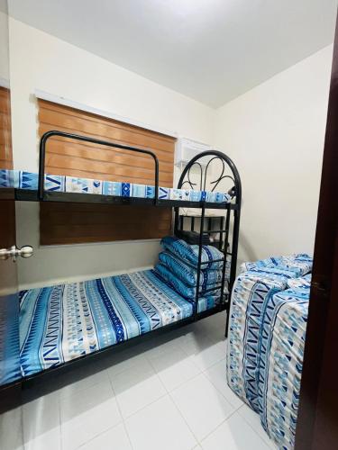 two bunk beds in a room with twounks at Richviel Transient House Lucena City Unit1 in Lucena