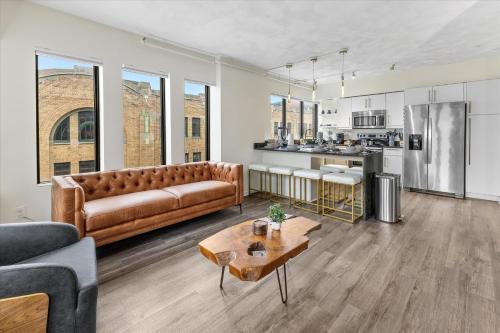a living room with a couch and a table at Modern Flat off Meridian - Walk Anywhere Downtown in Indianapolis