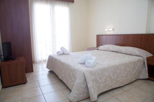 Postel nebo postele na pokoji v ubytování Summertime Inn