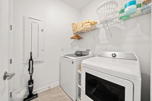 a laundry room with a washer and dryer at 390 Strand Drive in Melbourne Beach
