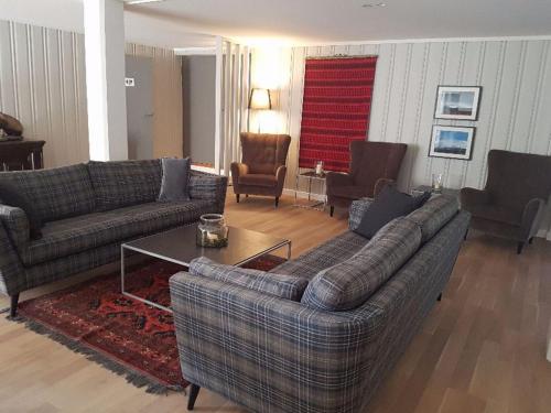 a living room with two couches and a table at Rondane Høyfjellshotell in Mysusæter