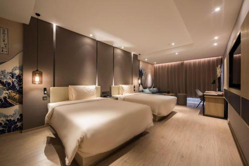Ένα ή περισσότερα κρεβάτια σε δωμάτιο στο Atour S Hotel Dongzhimen Beijing