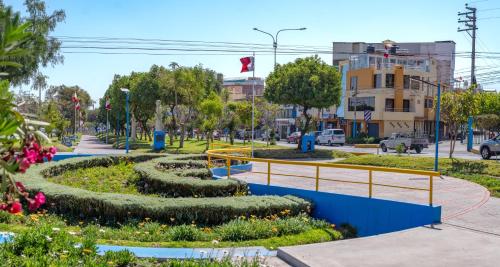 a street with a park with flowers and trees at Ssamana María Apartment & Guesthouse in Arequipa